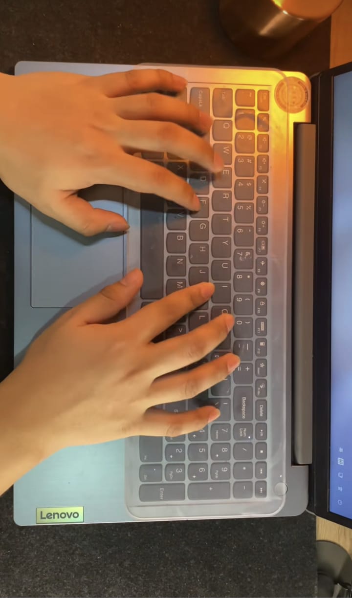 Typing on laptop with transparent keyboard protector
