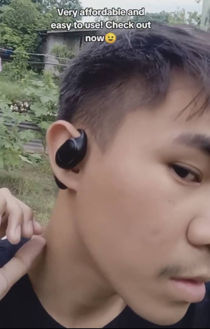 Person wearing Q22 TWS wireless earbuds - very affordable and easy to use