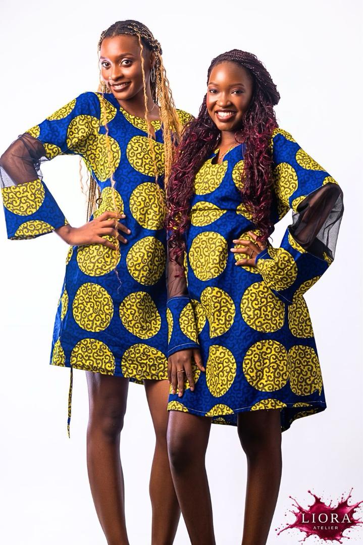 Liora Atelier Ankara Circle Print Mini Dress in blue and yellow wax print with sheer mesh sleeves